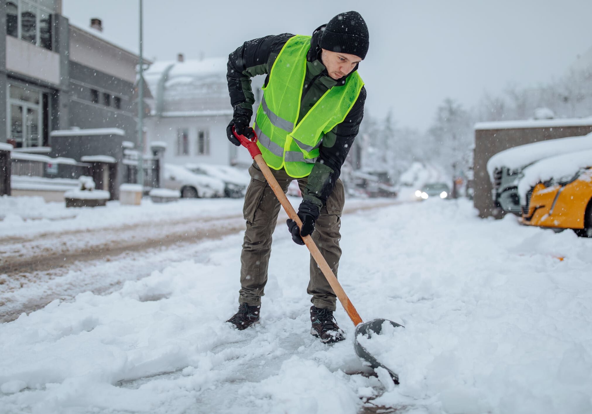 Worker clearing snow in winter conditions.